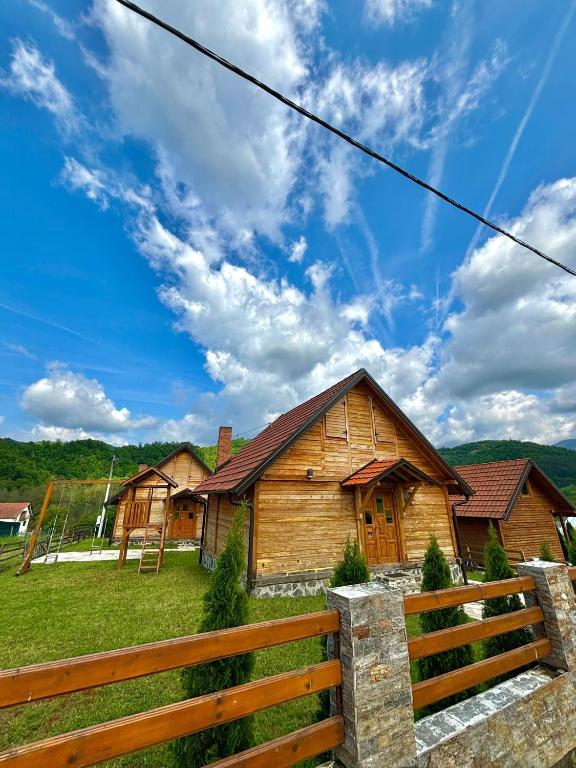 a wooden house with a fence in front of it at Vikendice Jovicic in Bukorovac
