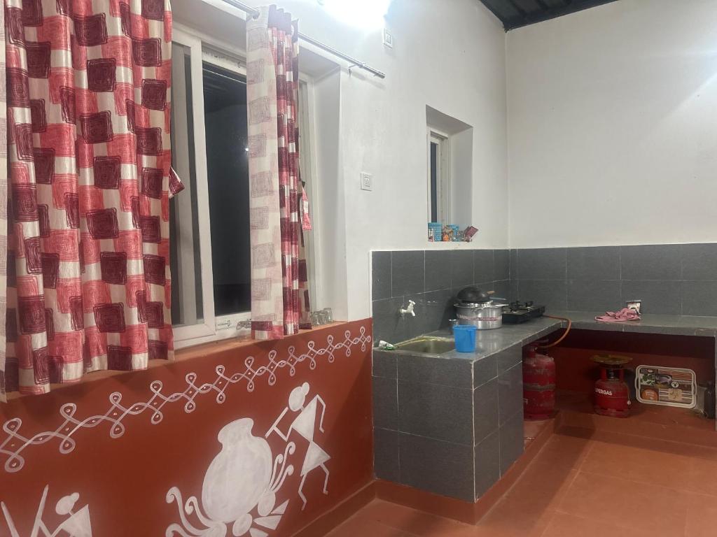 a bathroom with a sink and a window at Casa peace living in Pedda Ambarpet