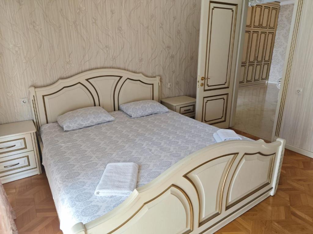 a bedroom with a white bed with two pillows at Liberty Square Accommodation I in Tbilisi City