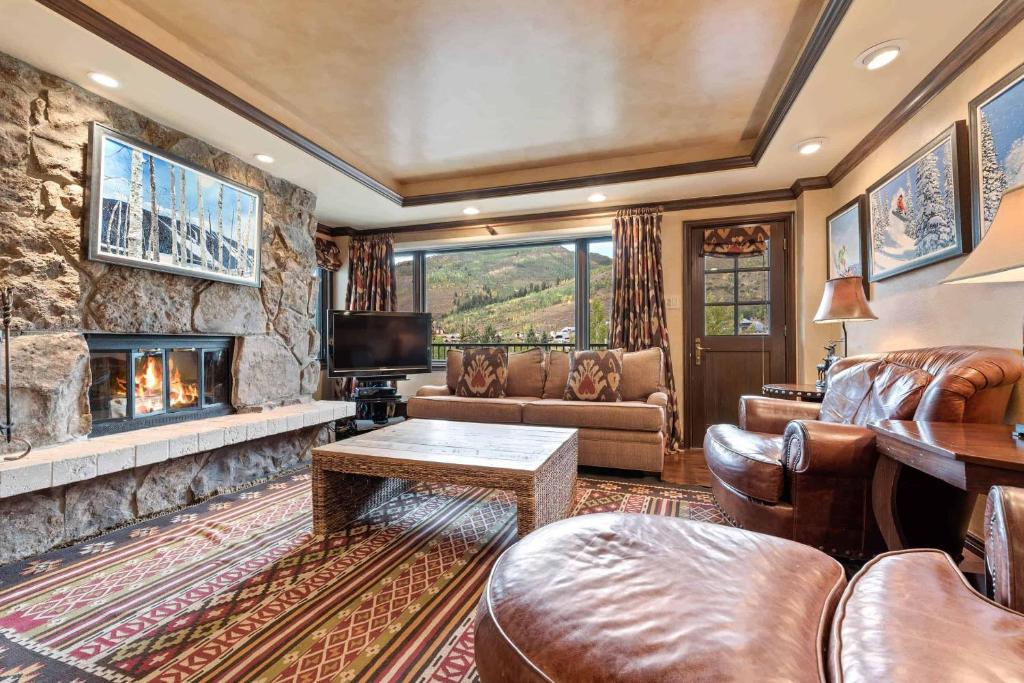 a living room with a couch and a fireplace at Lodge Tower 494 Two Bedroom Residence in Vail