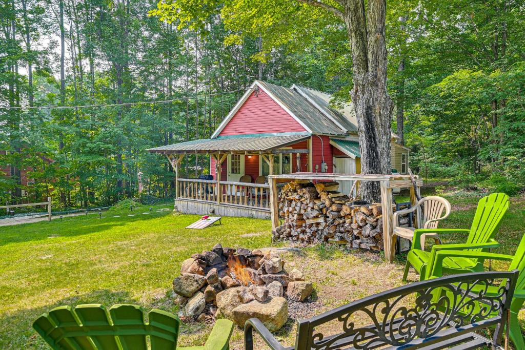 a house with a fire pit in front of it at Cottage Less Than 8 Mi to Gore Mountain in Bakers Mill! in Bakers Mills