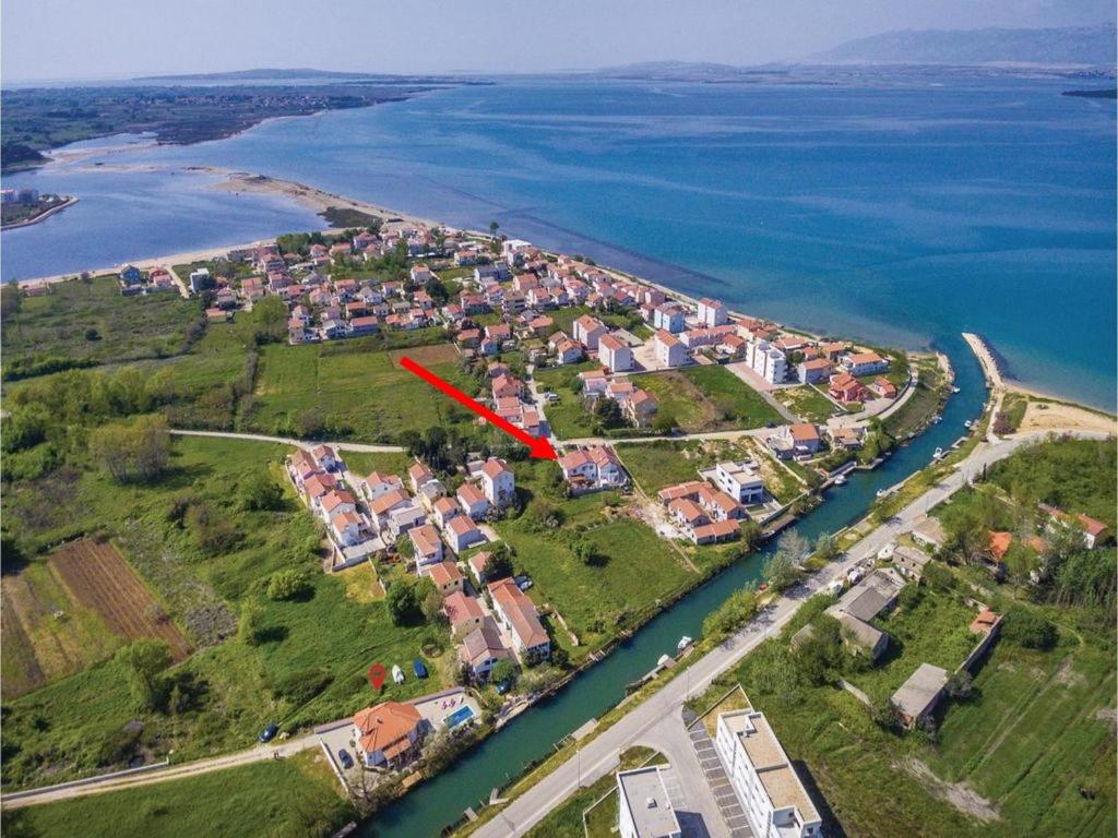 a red arrow is pointing to an island in the water at Studio apartman Kata Nin in Nin