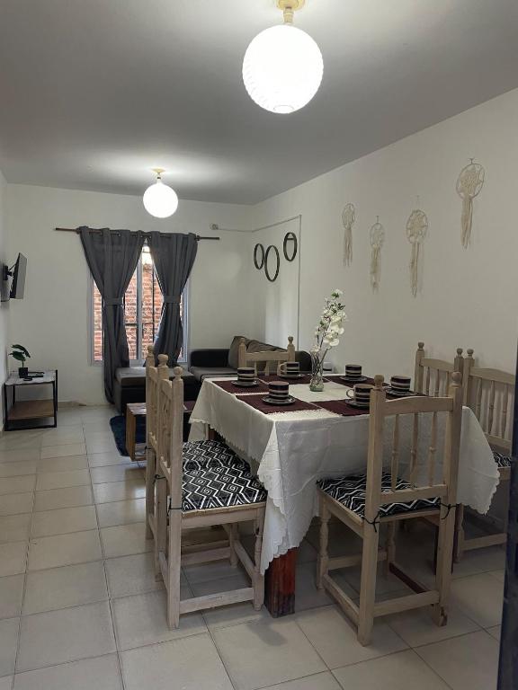 a dining room with a table and a couch at Dúplex cerca del Aeropuerto y Terminal de Ómnibus in Formosa