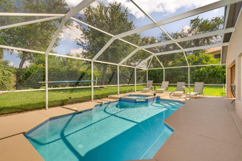 a swimming pool in a house with a glassconservatory at 4 Mi to Beaches Fort Myers Escape with Patio in Fort Myers