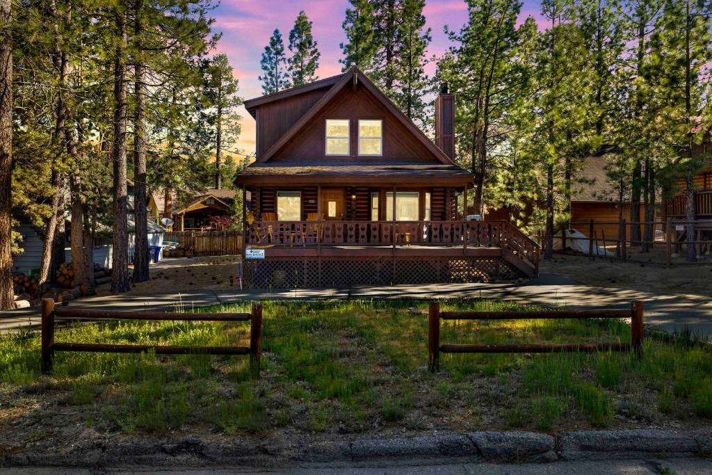 a house with two benches in front of it at Cub's Cabin #2561 in Big Bear Lake