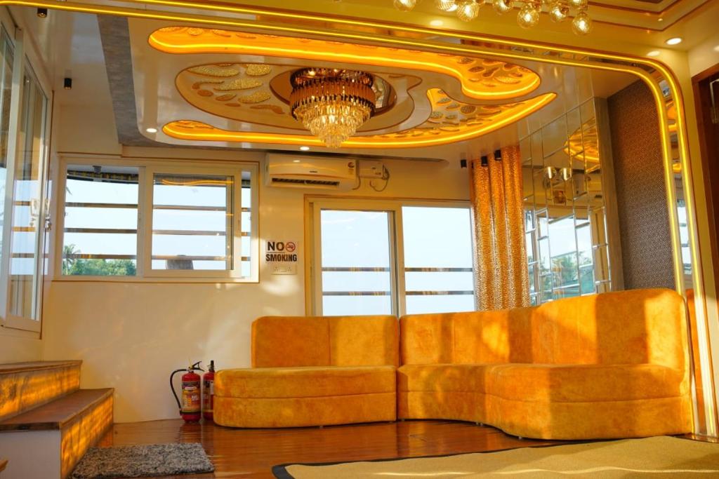a living room with a couch and a mirror at Green tourism Alleppey in Alleppey
