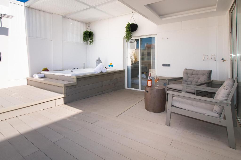 a large bathroom with a tub and a chair at Luxury Penthouse with Jacuzzi & Large Terraces by Passeig de Gràcia in Barcelona