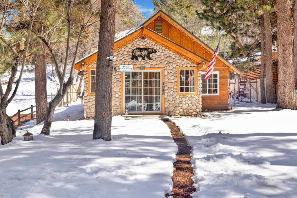 a cabin in the snow with an american flag at Lily's Bear Cabin #2544 in Big Bear Lake