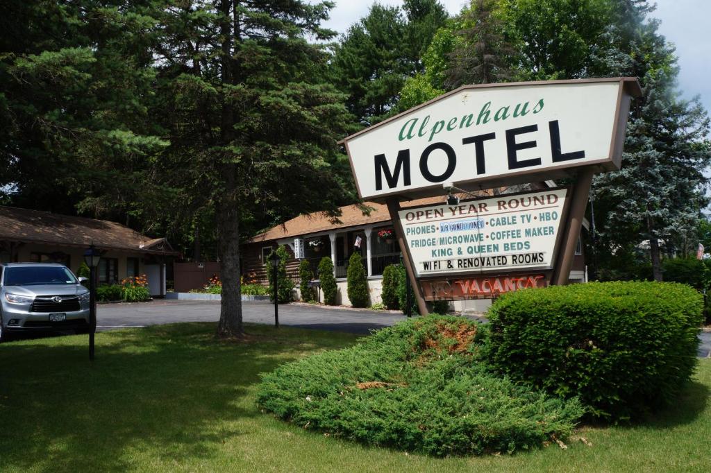 a sign for a motel in front of a building at Alpenhaus Motel in Queensbury
