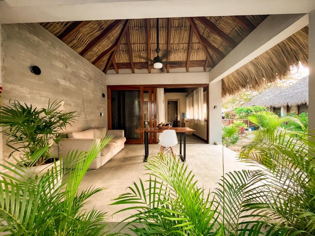 an outdoor patio with a table and some plants at Villa Rincón del surf, 50m spot surf, AC, Starlink, Alberca, Terraza, La Saladita in La Majahua