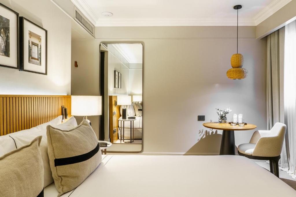 a hotel room with a bed and a table at Casa Lucia Member of Melia Collection in Buenos Aires