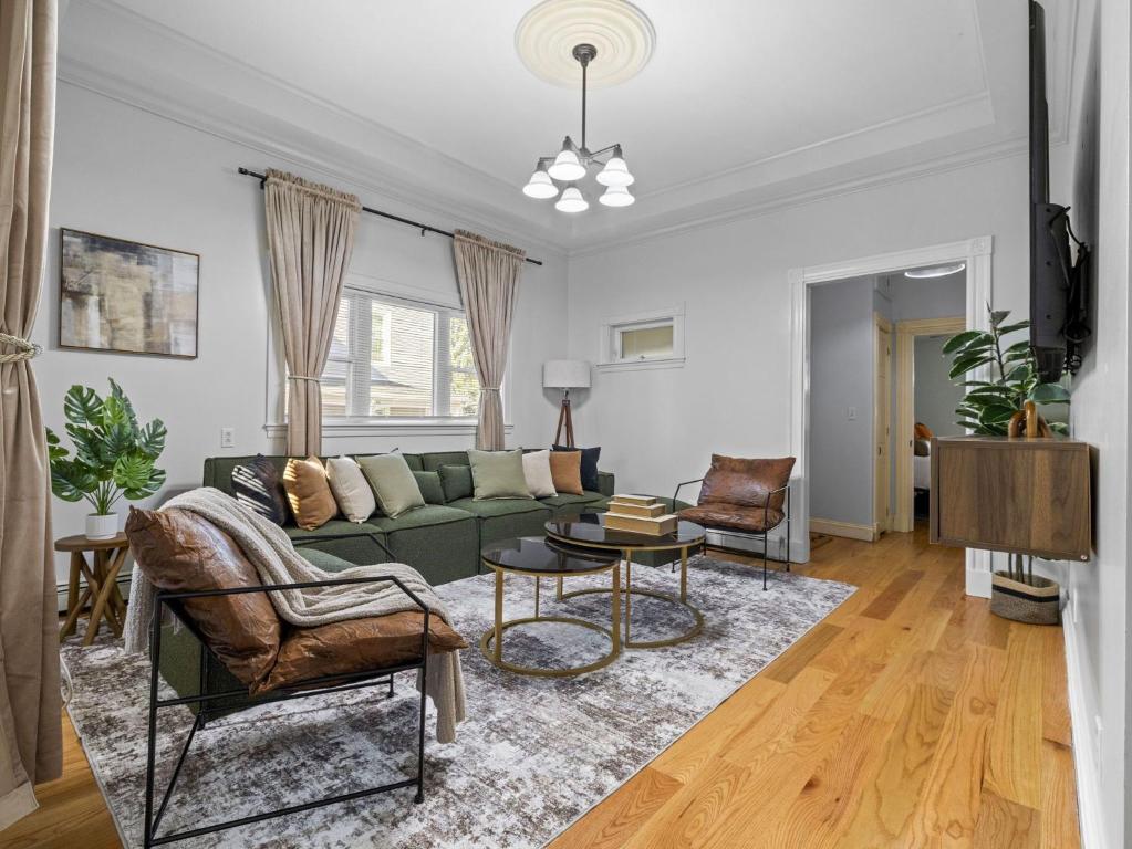 a living room with a green couch and chairs at Boston 4BR Home with Parking BBQ Fire in Somerville