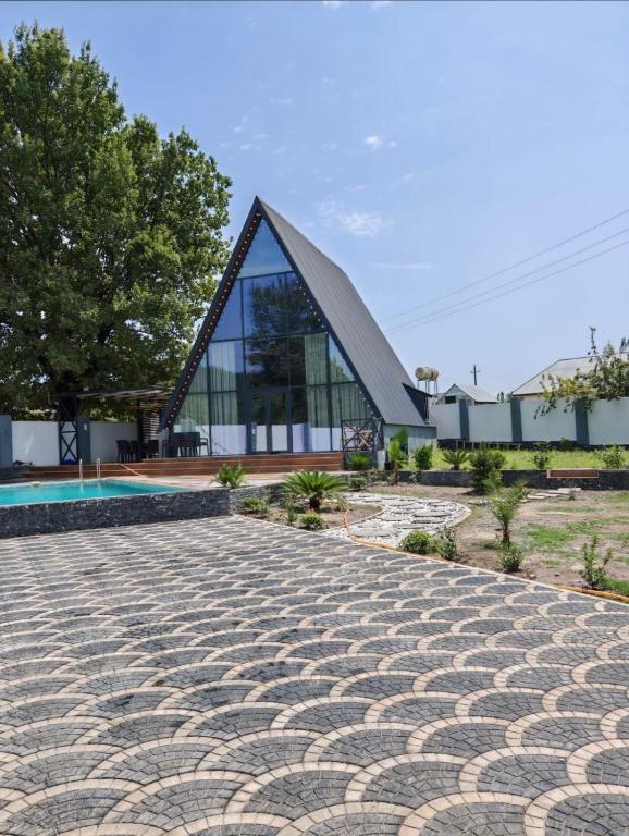 a house with a pyramid shaped roof at Huzoor Aframe Gabala in Gabala