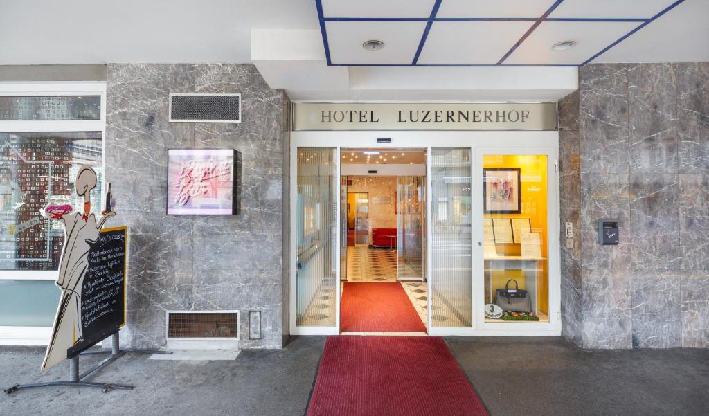 a lobby of a hotel with a red carpet at Hotel Luzernerhof in Lucerne