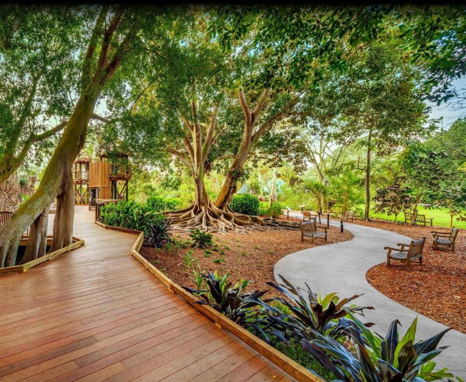 a walkway in a park with trees and benches at Comfortable Stay Near Golf Attractions Rm3 shared home in Sarasota