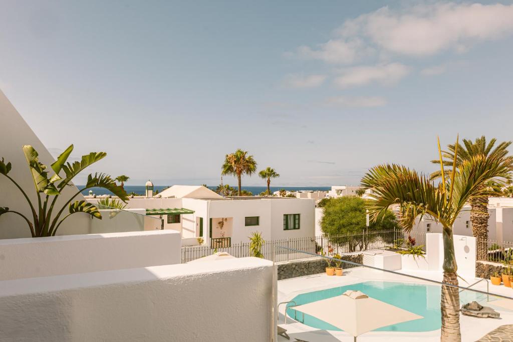 a view of the pool from the balcony of a villa at Apartamentos Princesa Guayadeque in Puerto del Carmen