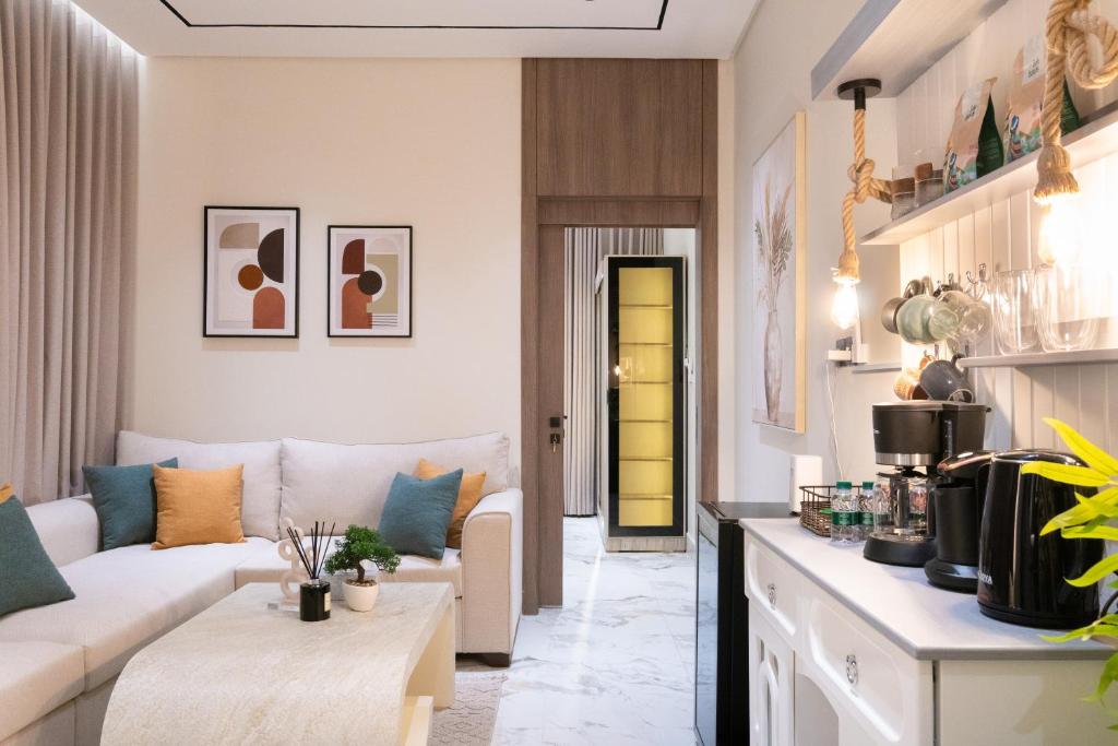 a living room with a couch and a table at Söz suites in Al Khobar