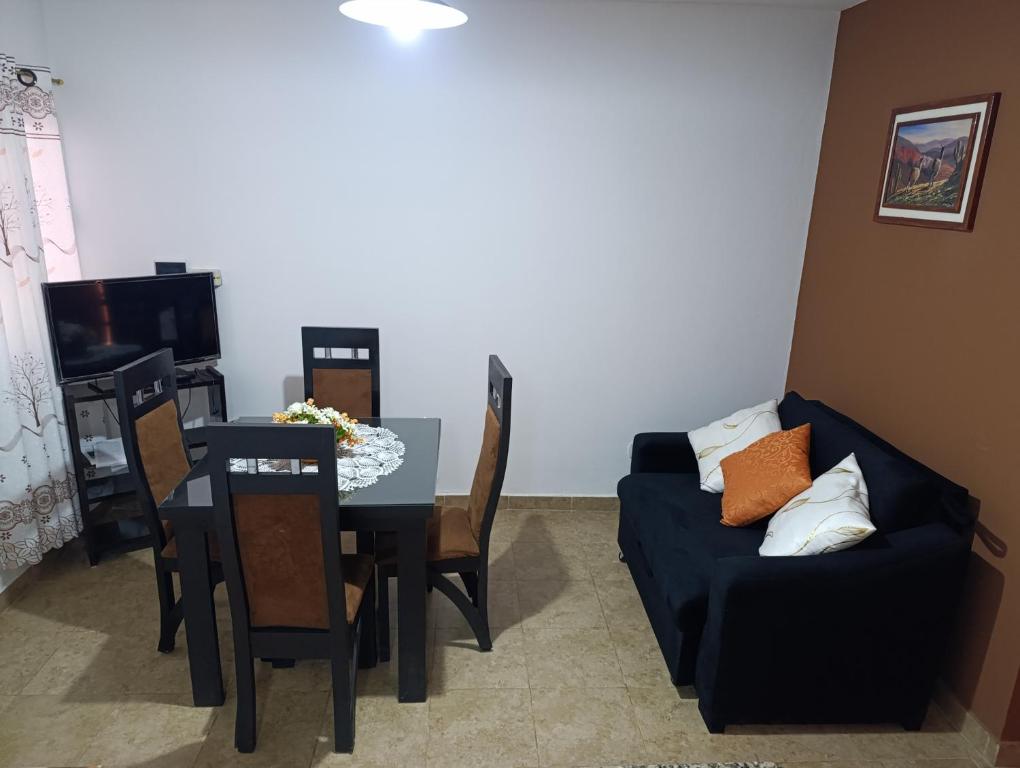 a living room with a table and a couch at Hospedaje Las Rosas in La Quiaca