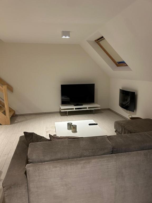a living room with a couch and a flat screen tv at Rotessa in Blankenberge