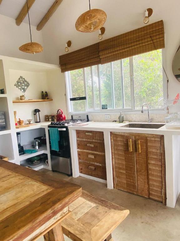 a kitchen with a sink and a stove at Samaya Corumbau in Corumbau