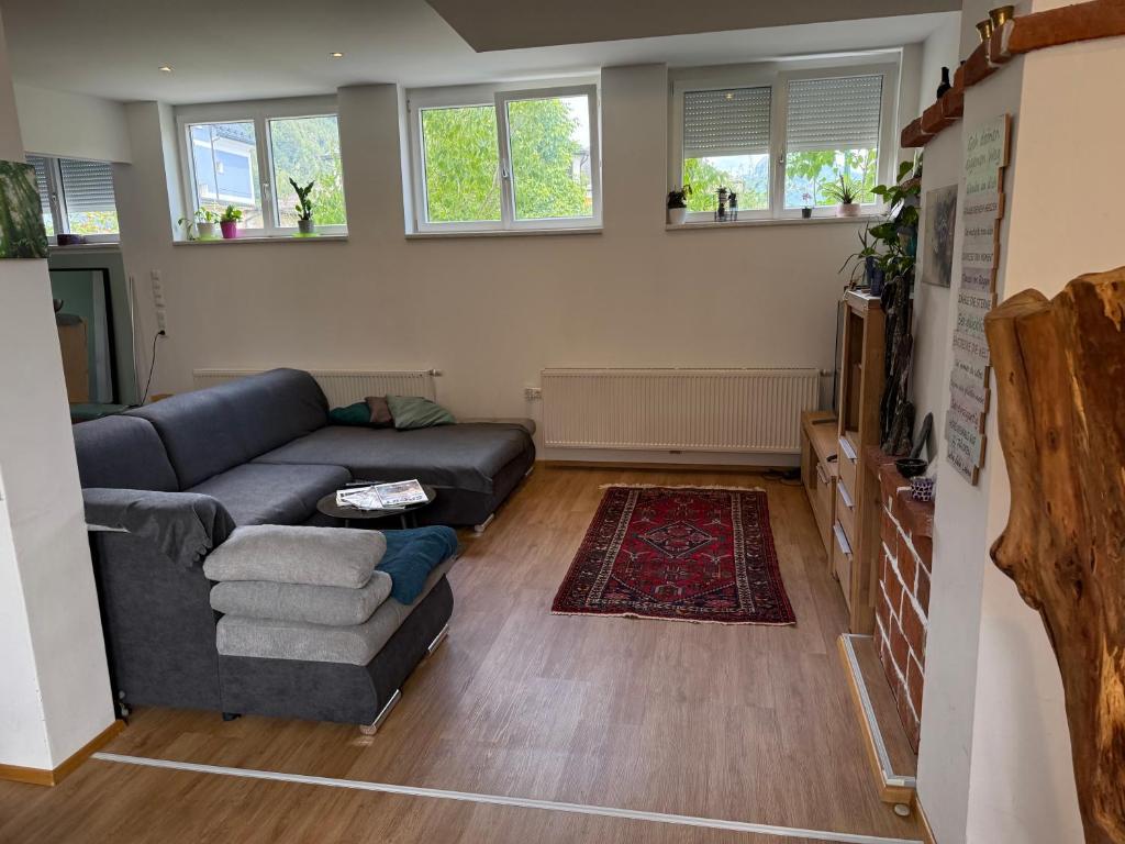 a living room with a couch and a rug at Urlaub am See oder am Berg in Ebensee