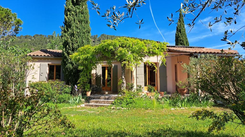an old house with trees in front of it at Maison Aksel in Beaumes-de-Venise