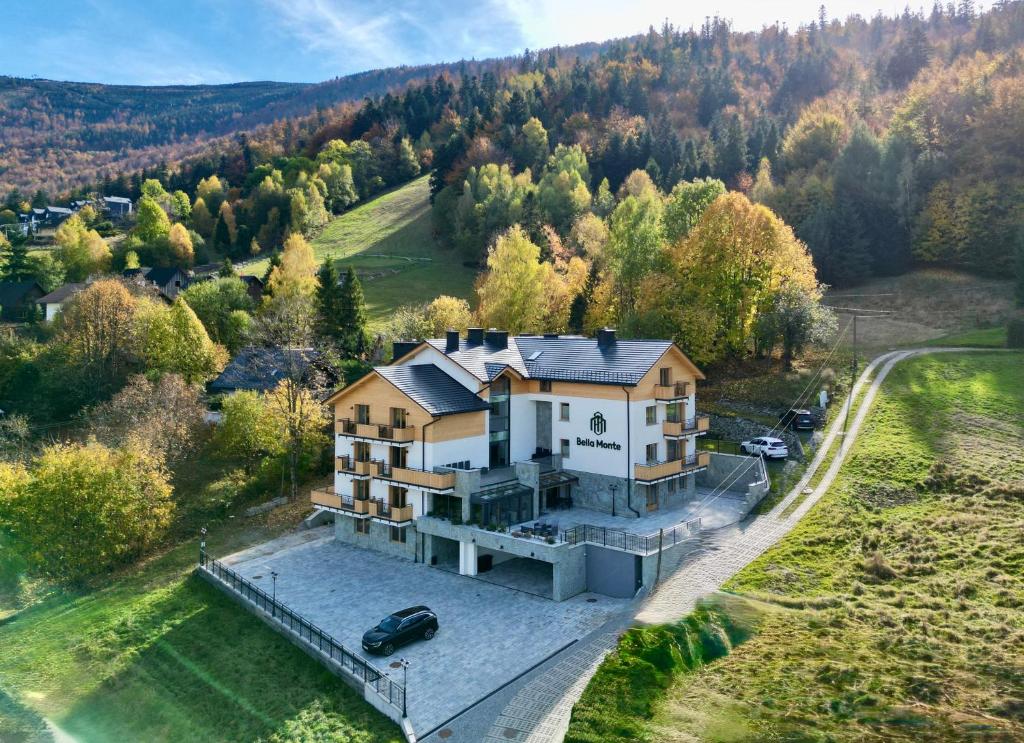 an aerial view of a house in the middle of a forest at Bella Monte in Szczyrk