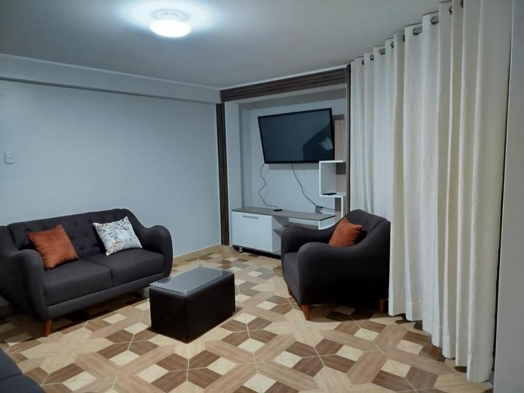 Μια τηλεόραση ή/και κέντρο ψυχαγωγίας στο Departamento familiar cómodo y acogedor
