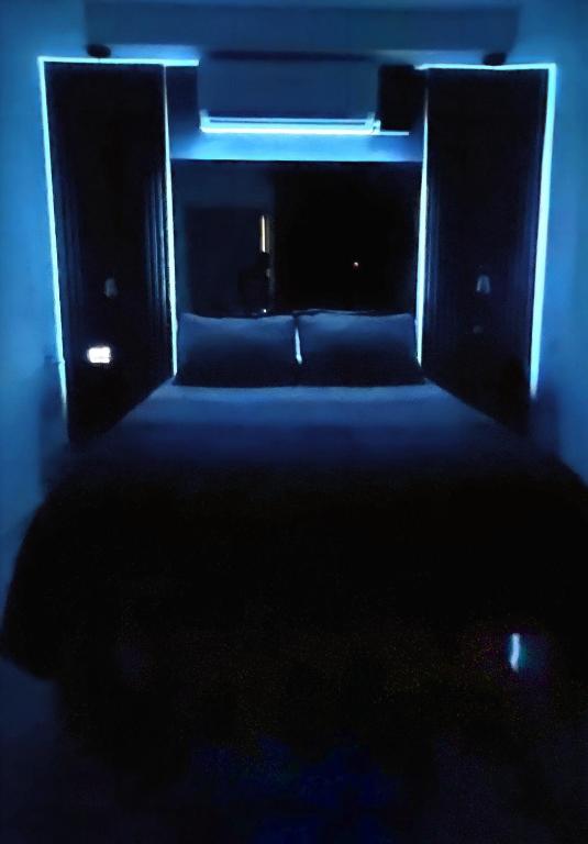 a dark room with a couch and a blue light at La Puerta Blanca #2 in Puerto Vallarta