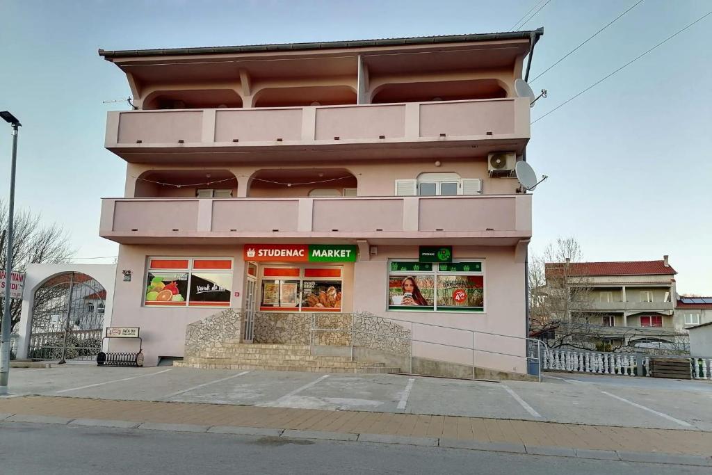 a building on a street corner with aermottermott at Apartments with parking space Lopar, Rab - 5019 in Lopar