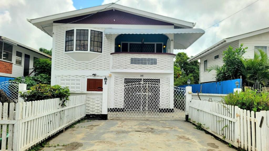 a white house with a white fence at South Oasis in Georgetown