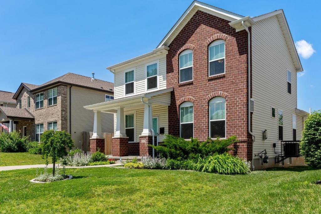 a house with a red brick at Modern Home w/Garage Near SLU | JZ Vacation Rentals in Soulard