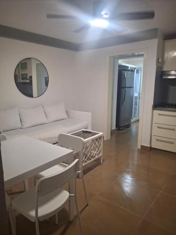 a living room with a white couch and a table at Spacious Condo with 2 queen beds in Sosua walking distance from everything in Sosúa