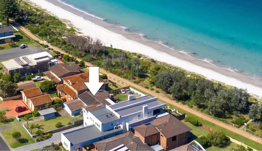 an aerial view of a house next to the beach at Bella Blu Beach House - direct beach access in Vincentia