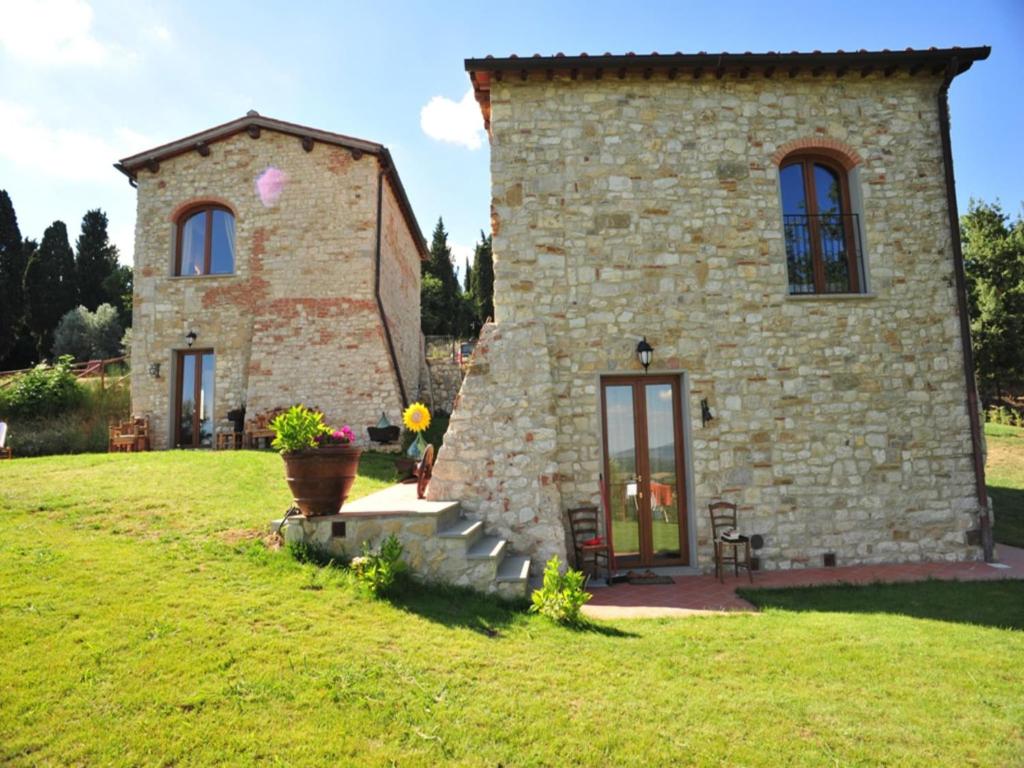 a large stone building with a grassy yard at Apartment with pool, Rignano in San Cristoforo a Perticaia