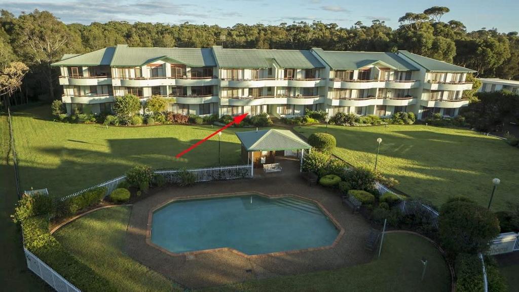 an aerial view of a large apartment building with a pool at Fathoms 2 - 2BR beach resort apartment in Mollymook