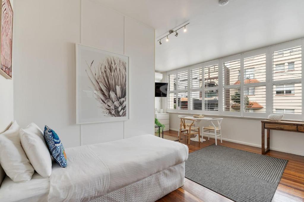 a living room with a couch and a table at Bay Court Iii - Spacious Studio Near Hayes Beach in Sydney