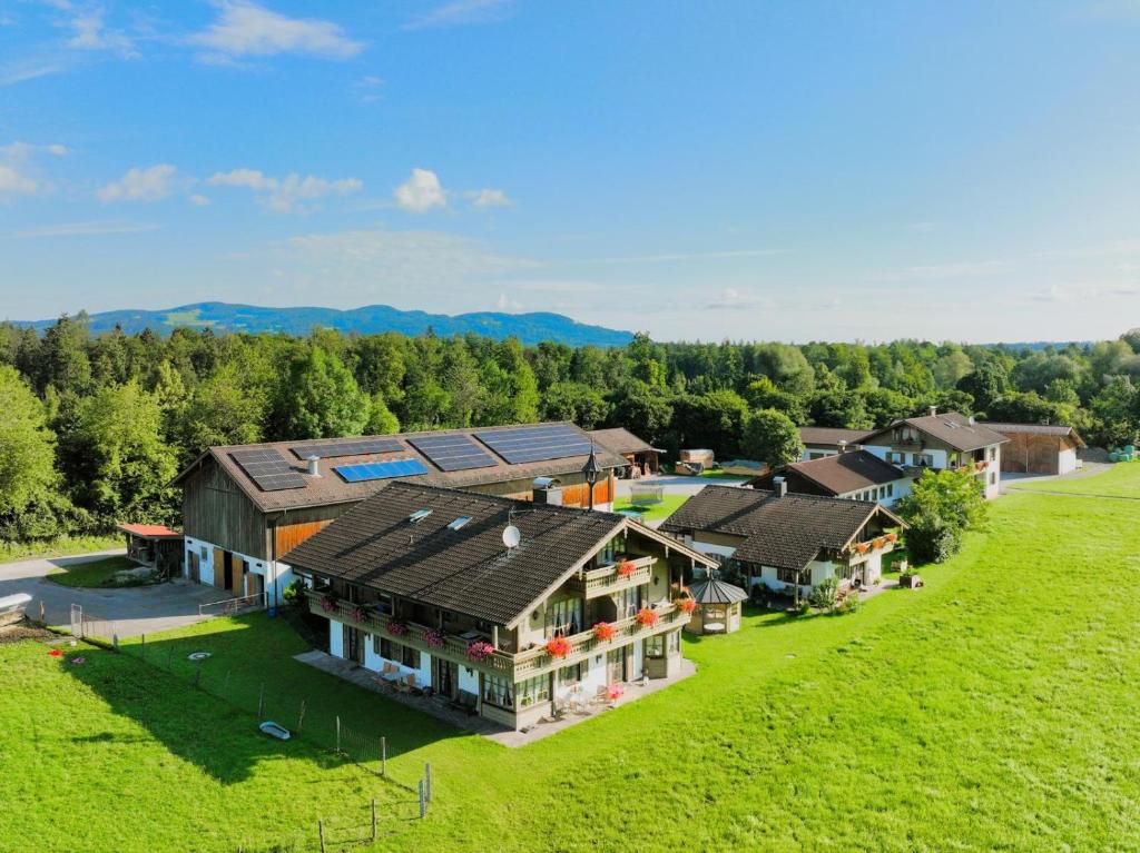 an aerial view of a house with a green field at Kleinreiterhof Ferienwohnungen Limmer in Bad Reichenhall