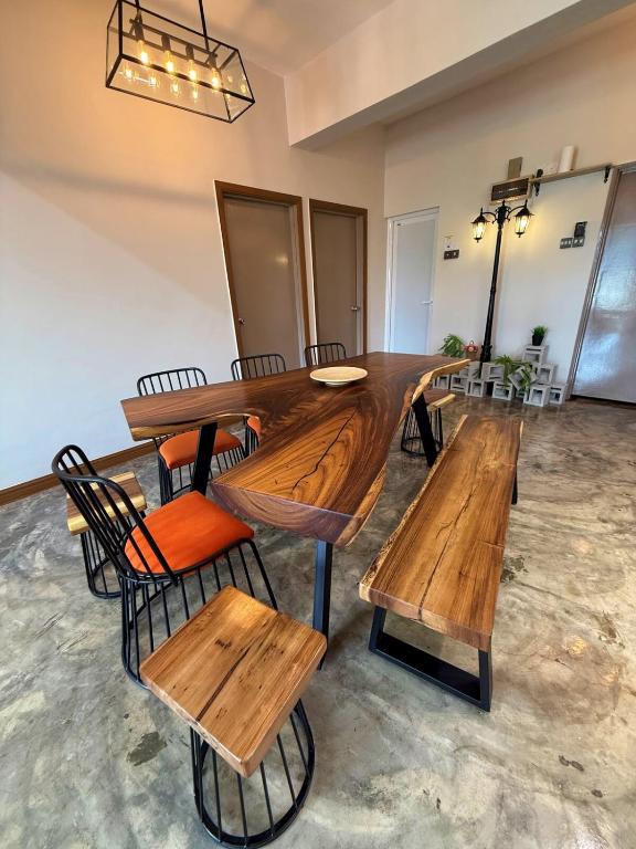 a large wooden table and chairs in a room at The Almost Touching the Stars Suite in Genting Highlands