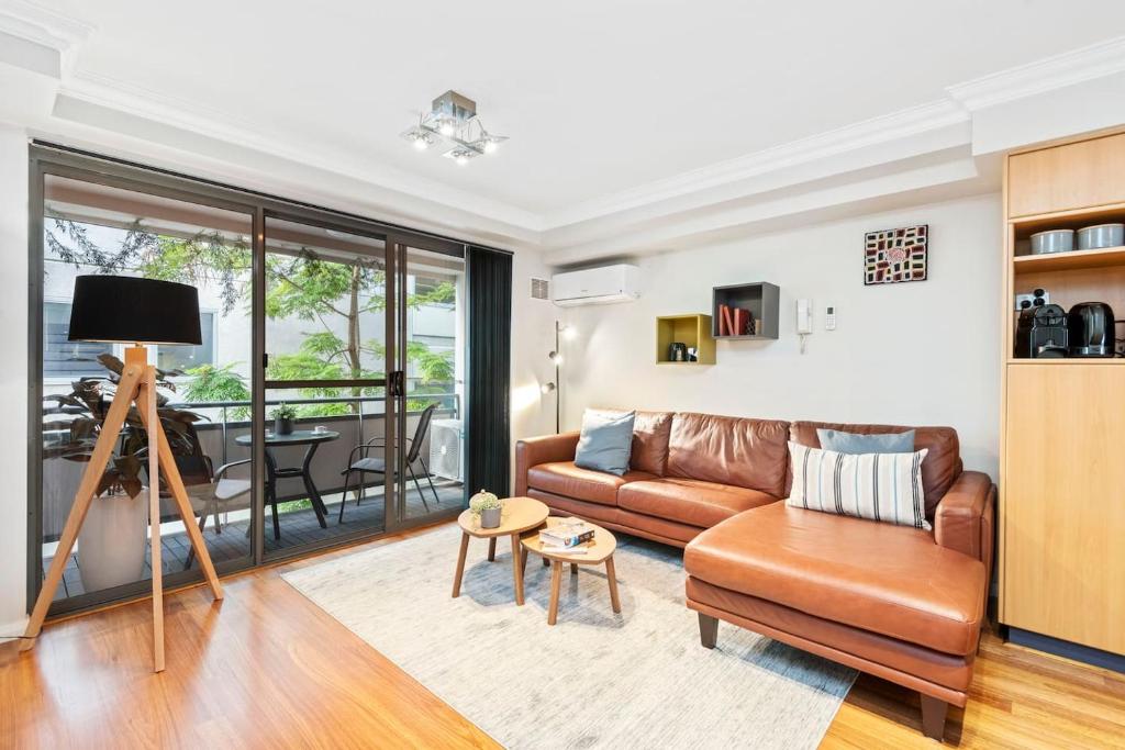 a living room with a couch and a table at 2 Royal Rest Quality 2br West Perth-parking in Perth