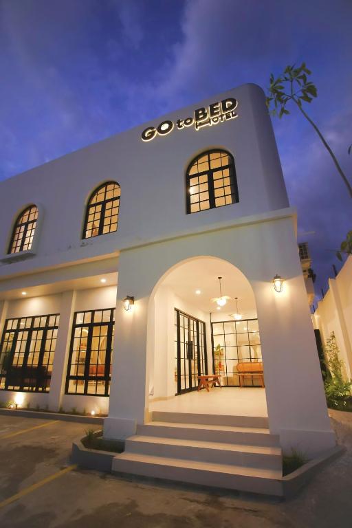 a white building with a sign on it at GOtoBED