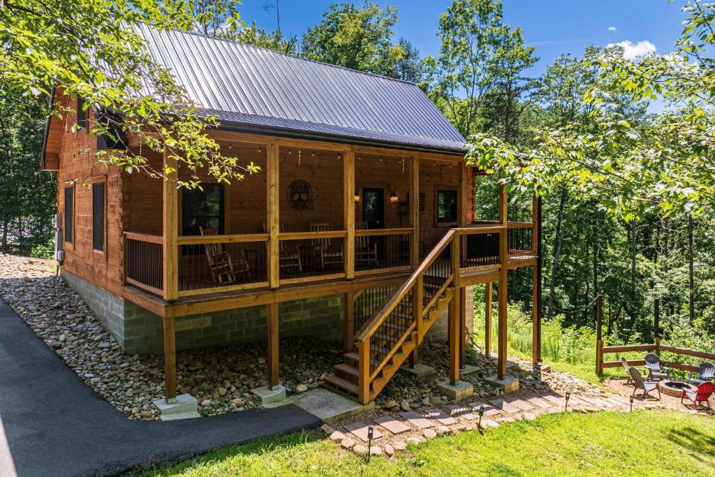 a large wooden house with a porch and stairs at Timber Ridge in Sevierville