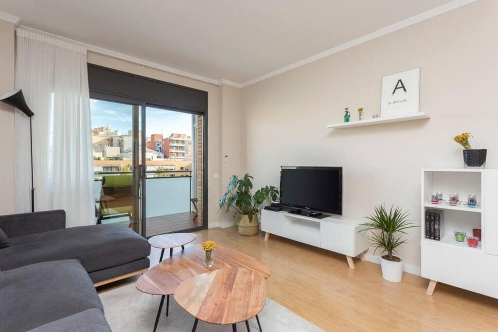 a living room with a couch and a table at New Apartment With Private Rooftop in Hospitalet de Llobregat