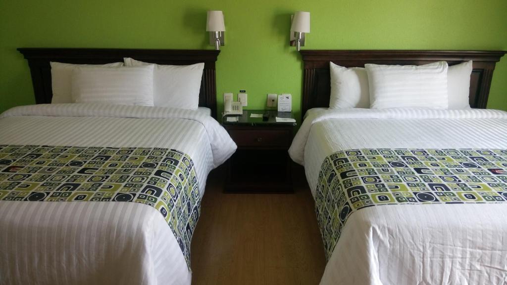 Postel nebo postele na pokoji v ubytování HG Hotel