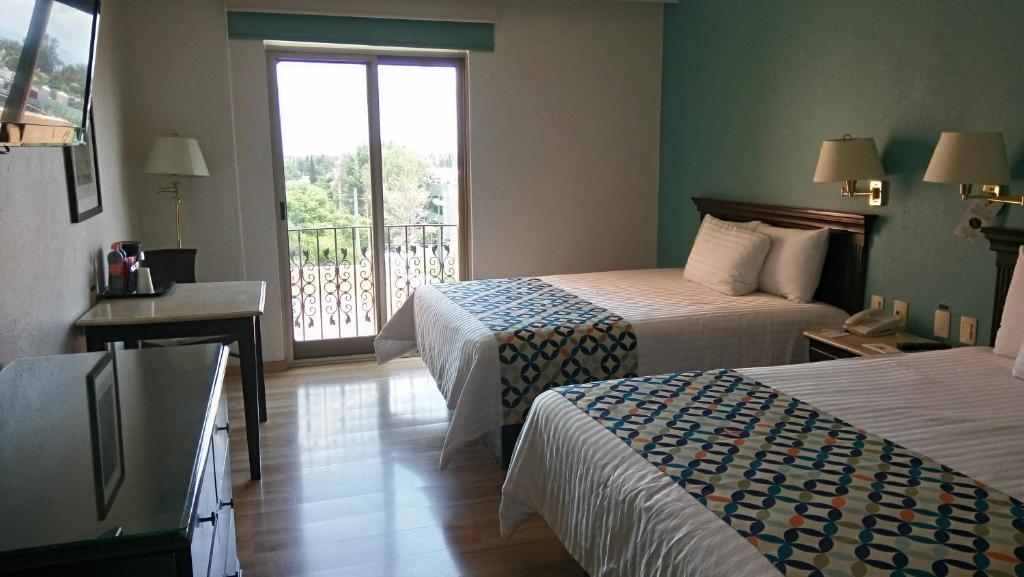 Postel nebo postele na pokoji v ubytování HG Hotel
