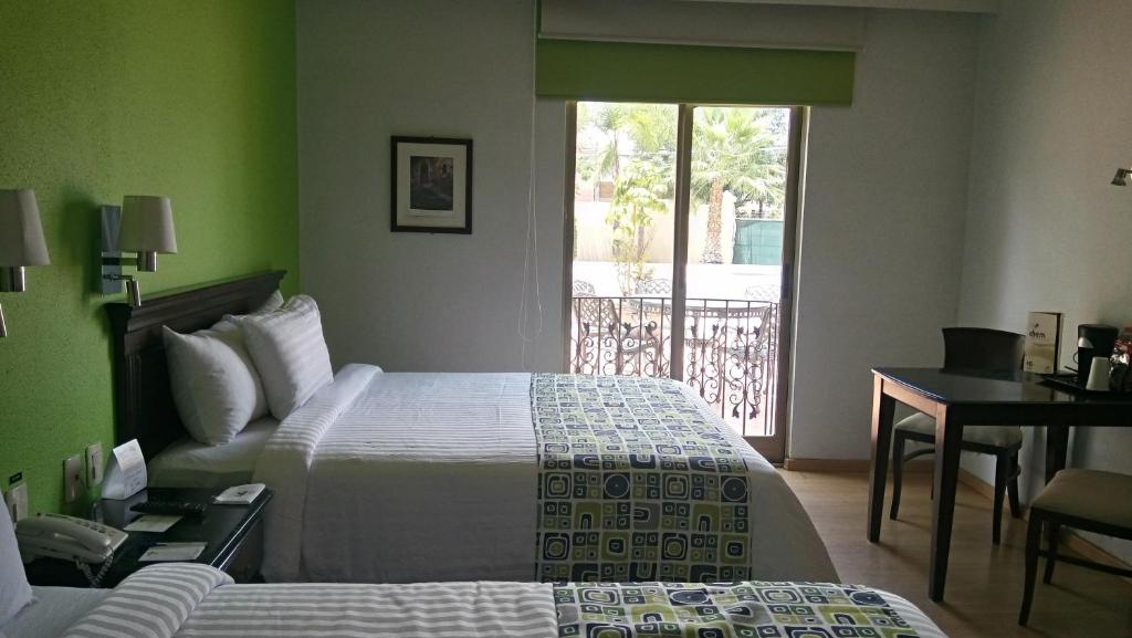 Postel nebo postele na pokoji v ubytování HG Hotel