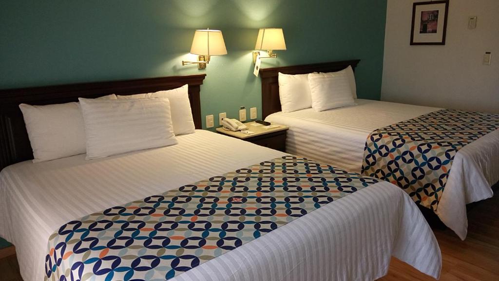 Postel nebo postele na pokoji v ubytování HG Hotel
