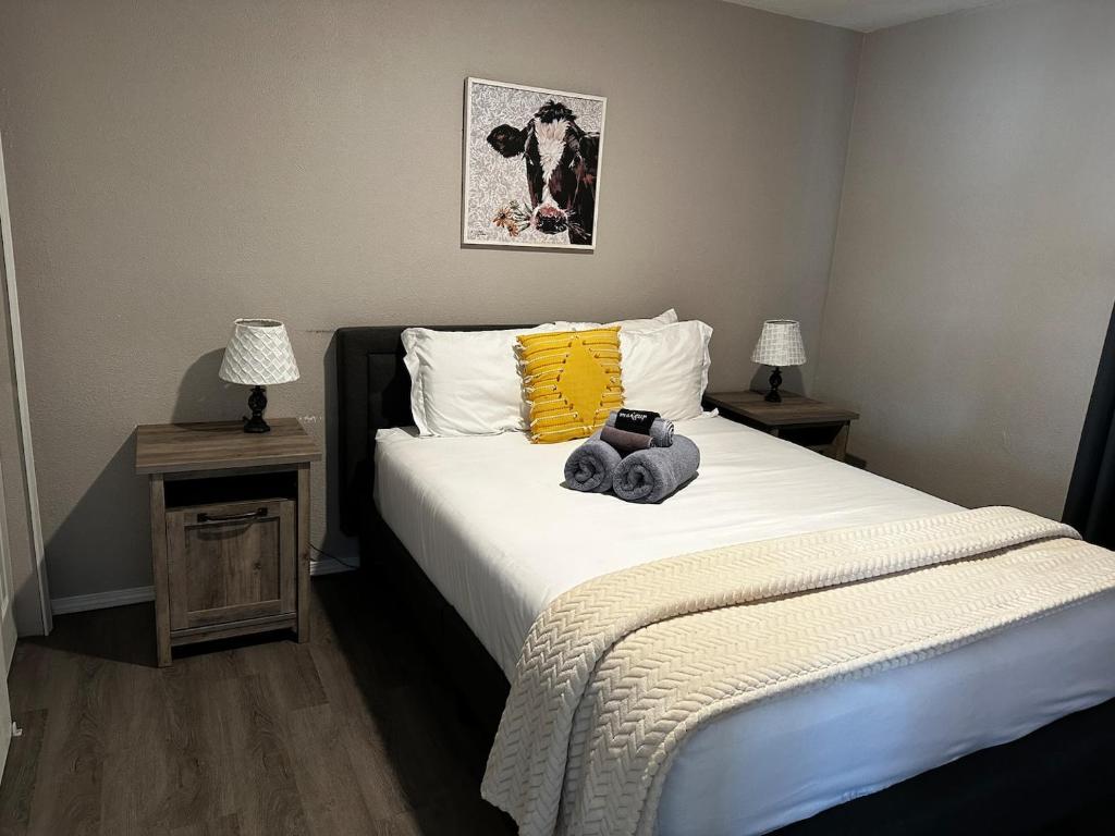 a bedroom with a bed with a camera on it at 1 Bedroom Wbalcony Near Unm, Nob Hill Downtown in Albuquerque