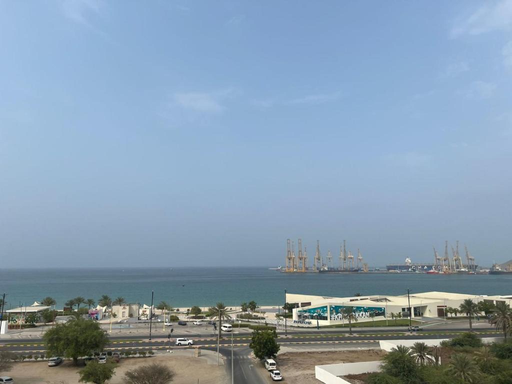 a view of the ocean and a harbor with ships at MANAZEL ladies and Family stay only corniche in Khor Fakkan