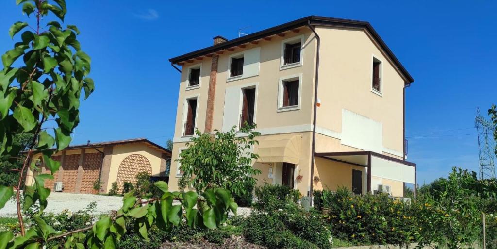 a large building with a blue sky in the background at Corte Bottura agriturismo in Castelnuovo del Garda